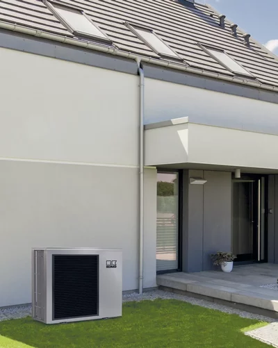 Remko heat pump installed outside a modern single-family home with a flat roof and skylights