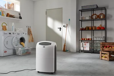 Remko dehumidifier in utility room next to washing machine and laundry basket